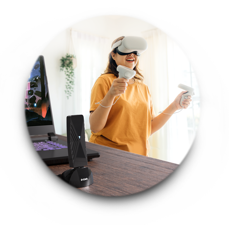Woman using VR to play VR in her living room with the DWA-F18 VR Air Bridge connected to a laptop nearby.