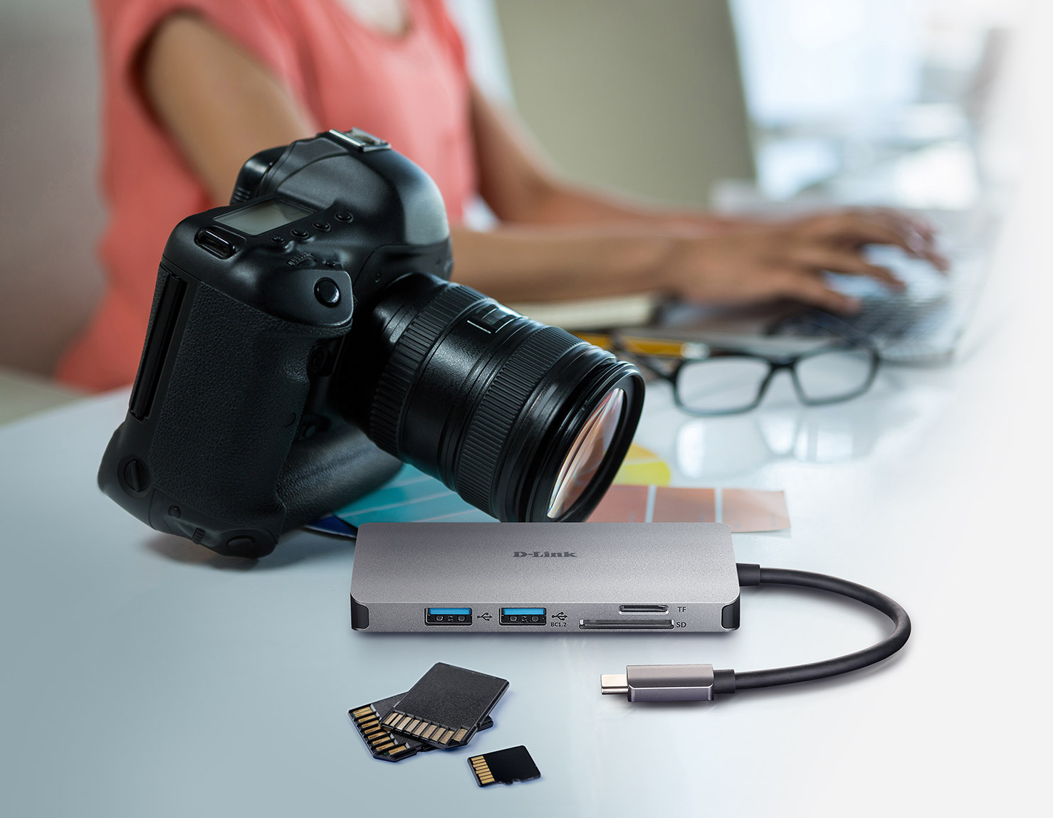 6-in-1 USB-C Hub with HDMI/Card Reader/Power Delivery next a camera and SD cards and microSD cards