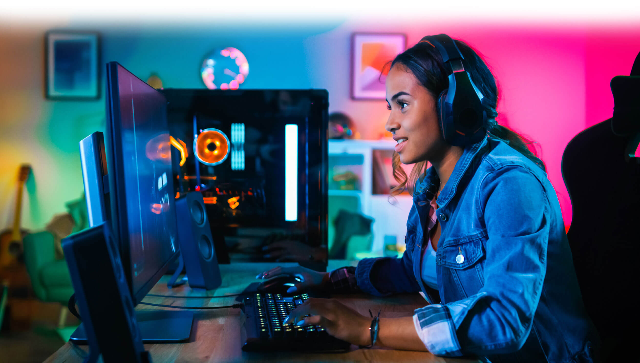 Girl gamer playing video game with high-tech gaming rig with colourful smart home lights in the background