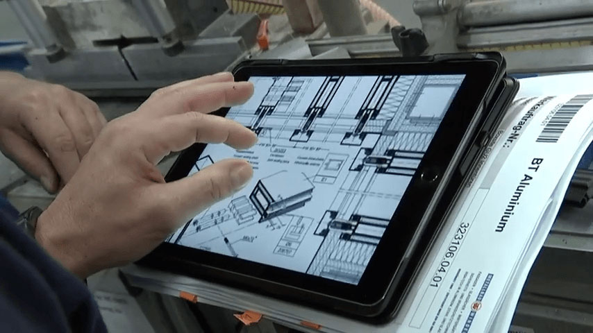 Man pinching to zoom-in on a floorplan on a tablet